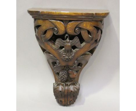 A 19th century carved oak hanging wall bracket of scrolling design with swan and fruit decoration, height 53cm, width 43cm, d