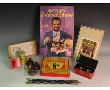 A large collection of magic and conjuring tricks, including a cast iron blindfold, various cup and ball sets, and other mater