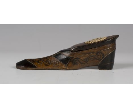 A 19th century mahogany and ebonized snuff box, moulded in the form of a shoe, with overall brass piqué inlaid decoration, le