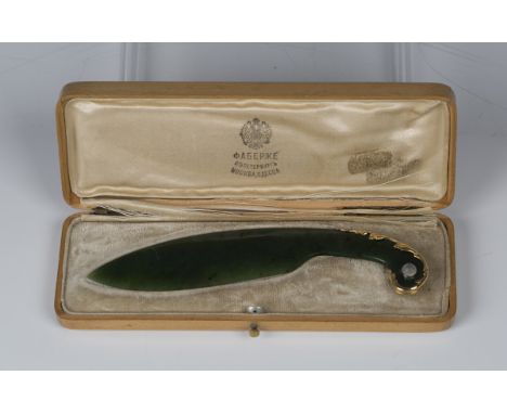 An early 20th century Fabergé gold mounted nephrite jade paper knife, 56 zolotnik, with curved blade, the scroll handle with 