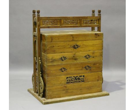 A Chinese softwood stacking storage trunk with pierced and carved overhead handle, height 111cm, width 87cm, depth 64cm.Buyer