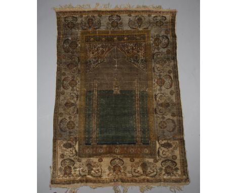 A fine Central Persian silk prayer rug, possibly Tabriz or Heriz, late 19th century, the green mihrab with architectural colu