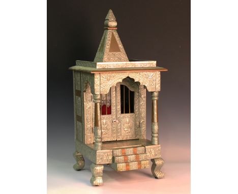 A mid-20th century nickel plate and copper mounted Hindu household shrine of architectural form, fitted with a pair of doors 