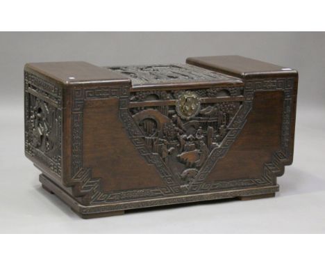 An early 20th century Chinese camphor trunk with carved decoration, the hinged lid on block feet, height 54cm, width 102cm, d