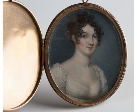 Follower of Adam Buck - a late 18th/early 19th century watercolour on ivory portrait miniature of a young lady wearing a whit