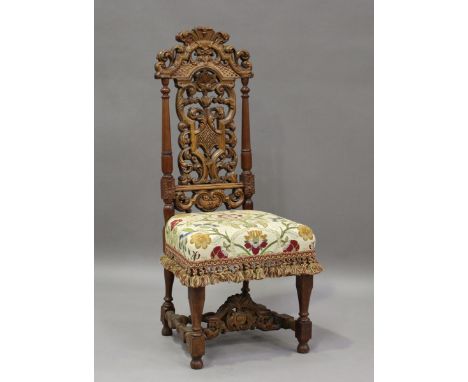 A 19th century Charles II style walnut hall chair with a profusely carved back and tapestry style seat, height 124cm, width 5