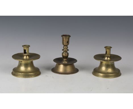 A pair of Dutch Heemskirk type brass candlesticks with pierced nozzles and bell shaped bases, height 11cm, together with anot