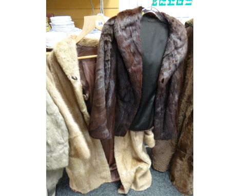 A light coloured long fur coat together with a short dark fur jacket Condition reports provided on request by email for this 