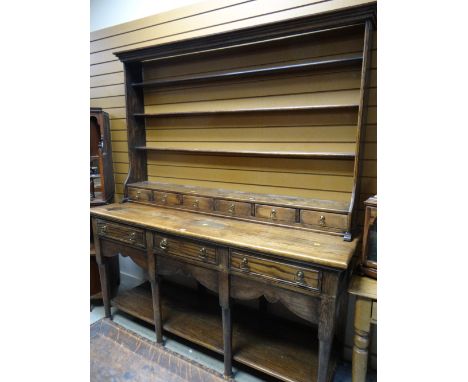 A twentieth century Welsh-type dresser having a configuration of four drawers to the base, six spice drawers to the open rack
