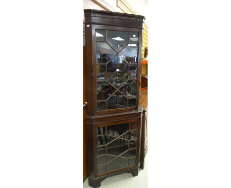 An antique mahogany standing corner cabinet with astragal glazed base and top and having a dentil frieze on bracket feet, 76c