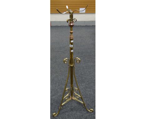 A vintage brass tripod floor standing oil lamp base, 125cms high