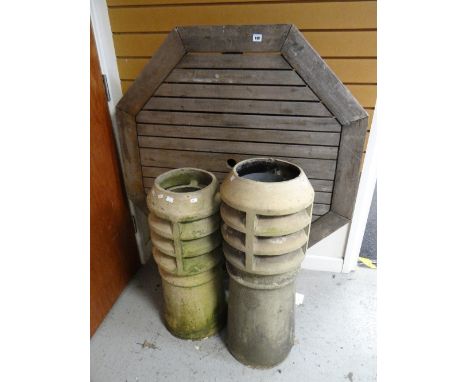 Two teak garden tables together with two ceramic chimney pots for use as garden planters Condition reports provided on reques