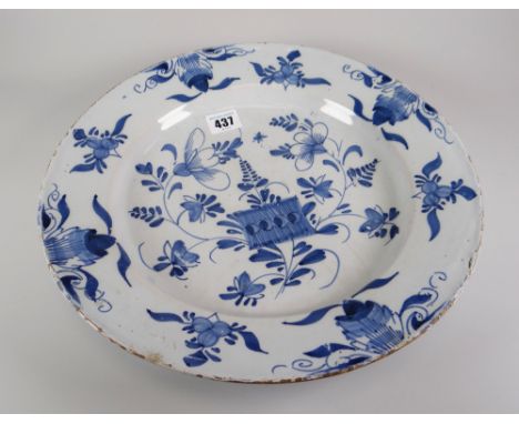 A mid eighteenth century English Delftware charger-dish decorated in naive blue flowers and insects, 33cms diam Condition rep