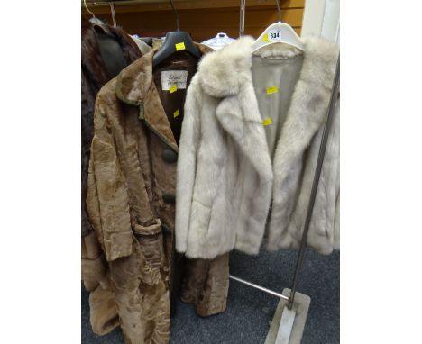 A National Fur Company long hide coat together with a light coloured fur jacket Condition reports provided on request by emai