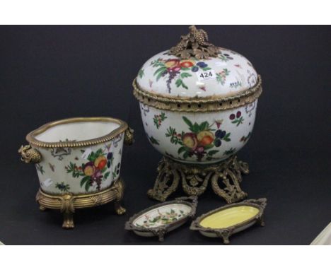 A large decorative ceramic centrepiece, with gilt metal mounts, along a tureen in a similar style and two dishes