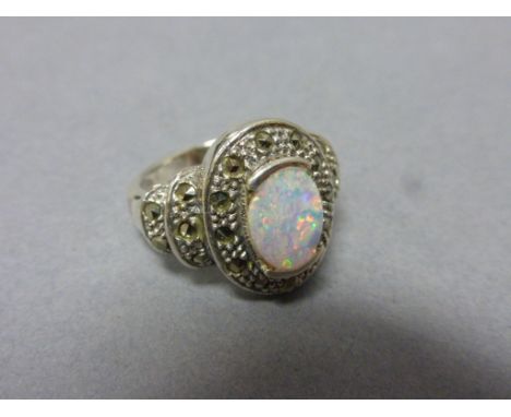 Silver and marcasite ring inset with with a large central opal