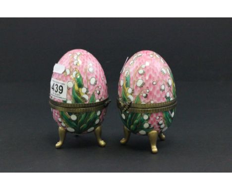 Two decorative ceramic eggs, each on a gilt metal mount  