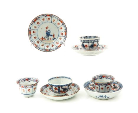 In iron red, blue and gilt enamels, depicting Chinese figures in garden, largest saucers are 11 cm. in diameter, chip and hai