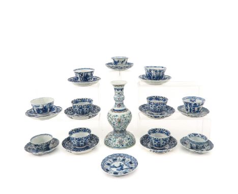 Including candlestick, 11 cups, and 12 saucers, candlestick is 23 cm. tall and marked Qianlong, chip and hairline.