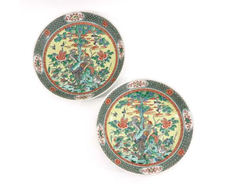 Depicting scene in garden with birds of paradise, floral decor border, 54 cm. in diameter, marked Yongzheng and Kangxi.