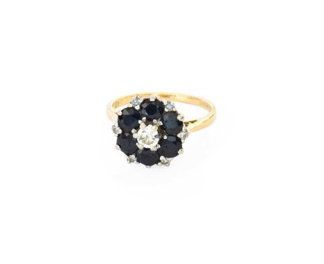 An 18 Carat Gold Sapphire and Diamond Cluster Ring, the round brilliant cut diamond within a border of round cut sapphires, s