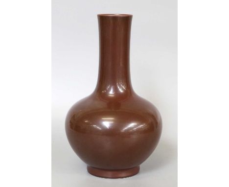 A Chinese Porcelain Bottle Vase, impressed Qianlong seal mark but not of the period, decorated in an overall iron rust glaze,