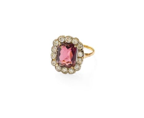 A Purple Glass and Diamond Cluster Ring, the emerald-cut purple glass within a border of old cut diamonds, in white claw and 
