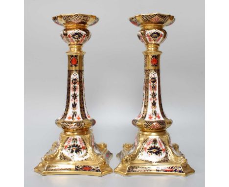 A Pair of Royal Crown Derby Imari Porcelain Table Candlesticks, raised on dolphin moulded plinths, pattern 1128, 27cm high (2