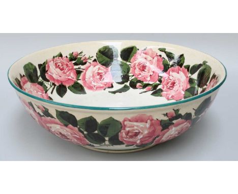 A Wemyss Pottery Basin, decorated with large pink cabbage roses between green line borders, painted mark and retailer mark fo