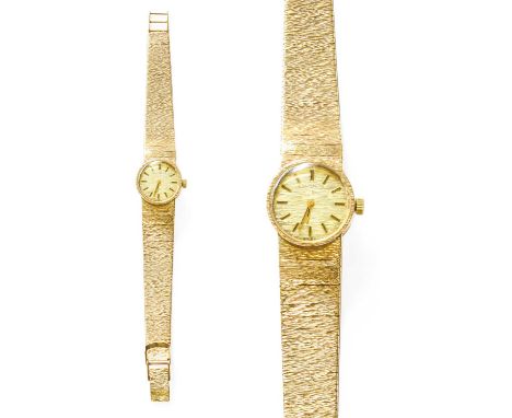 A Lady's 9 Carat Gold Longines Wristwatch, manual wound lever movement, integral bark finished bracelet with clasp stamped wi