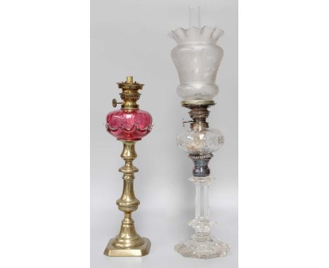 A Cut Glass Chamber Oil Lamp, with etched shade, together with a brass-based oil lamp with cranberry reservoir (2)