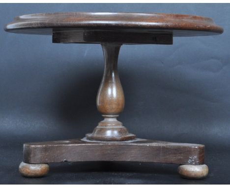 A vintage 20th century apprentice piece miniature mahogany tilt top table in the manner of J Bubb having a circular tabletop 