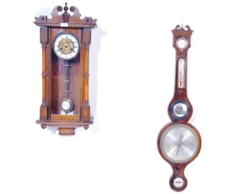 A 19th century Victorian Vienna Regulator style 8 day clock having a carved pediment top with a brass and enamel clock face o