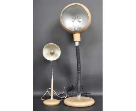 A retro vintage mid 20th century table lamp having an oval shaped shade with a corrugated tubular support raised on a circula