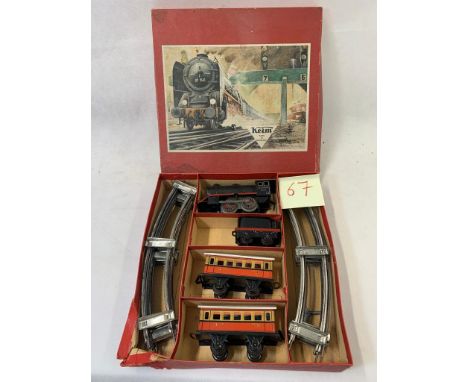 (W. German) 0 gauge clockwork passenger set with 0-4-0 engine and tender with 2 4 wheel carriages. All tin plate with track  