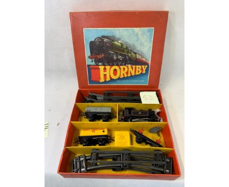 Hornby 0 gauge clockwork goods set no 45 with 0-4-0 tank engine no 82011 in black with 3 goods cars, 1 open, 1 flatbed, 1 she