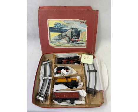 0 Gauge clockwork goods set with 0-4-0 engine & tender in black. With Shell fuel tanker and open freight wagon & track unknow