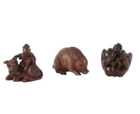 A GROUP OF THREE JAPANESE CARVED WOOD NETSUKE including a late 19th century example, modelled as a warthog, signed to the bas