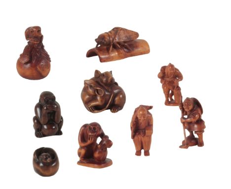 A GROUP OF NINE JAPANESE NETSUKE the tallest example, a monkey seated on a bag, 6cm high, the shortest, a bat with curled win