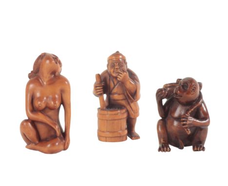 A GROUP OF THREE JAPANESE CARVED WOOD NETSUKE including an example figured as a monkey eating fruit, signed to the base, 4cm 