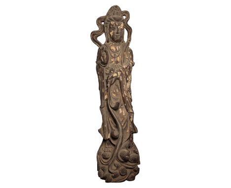 A MONUMENTAL CHINESE LACQUERED WOOD FIGURE OF GUANYIN Qing or later, standing on a wave-scroll base, 204cm high