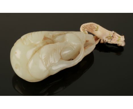 A CHINESE PALE CELADON JADE PENDANT Qing, carved as a gourd with leaves, 6cm long