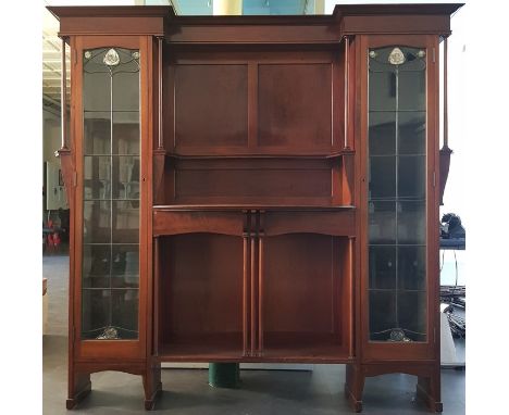 A Liberty & Co. Art Nouveau mahogany wall cabinet, c.1900, having shaped shelves and pillasters to centre flanked by two lead