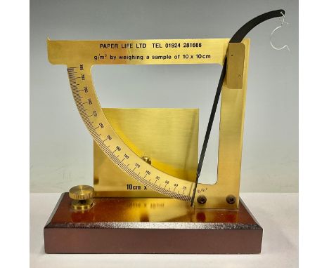 A brass paper scale balance, Paper Life Ltd, g/m2 by weighing a sample of 10 x 10cm, mahogany rectangular base, 19cm 