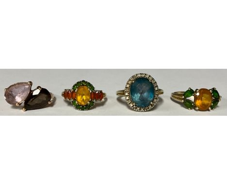 A 9ct gold ring set with a central blue stone and cubic zirconia, size O, marked QVC 375, three similar 9ct gold dress rings,