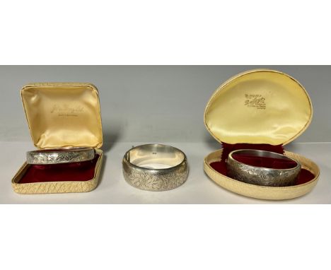 A silver hinged bangle, Birmingham 1964; two others similar, 89.9g gross, 