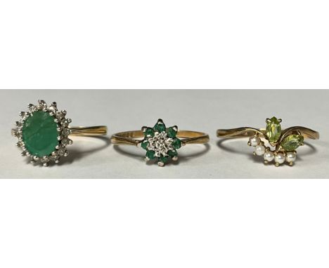 A 9ct gold emerald and diamond cluster ring, size N/O, marked 375, 2g, boxed; two other 9ct gold rings, set with green stones