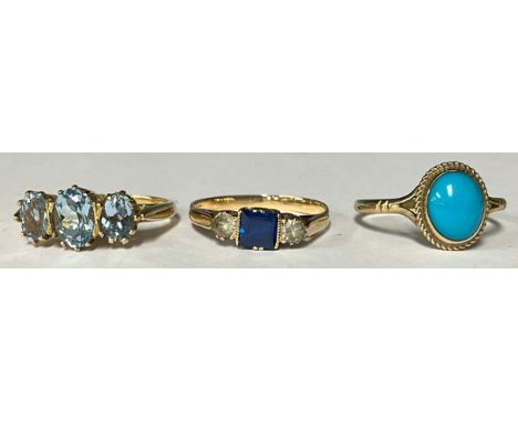 A 9ct gold ring set with a single polished oval turquoise cabochon, size P, marked 375, 1.6g; a 9ct gold graduated three ston