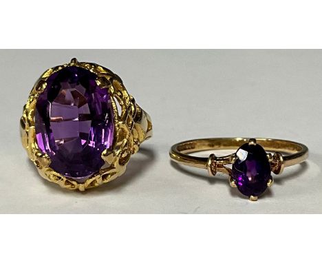 A late 19th/early 20th century 9ct gold dress ring, set with a single faceted amethyst, size M/N, marked 9ct, 4.8g; another s