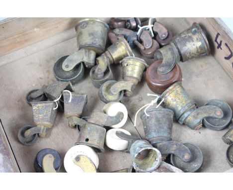 A collection of antique castors - brass and ceramic 